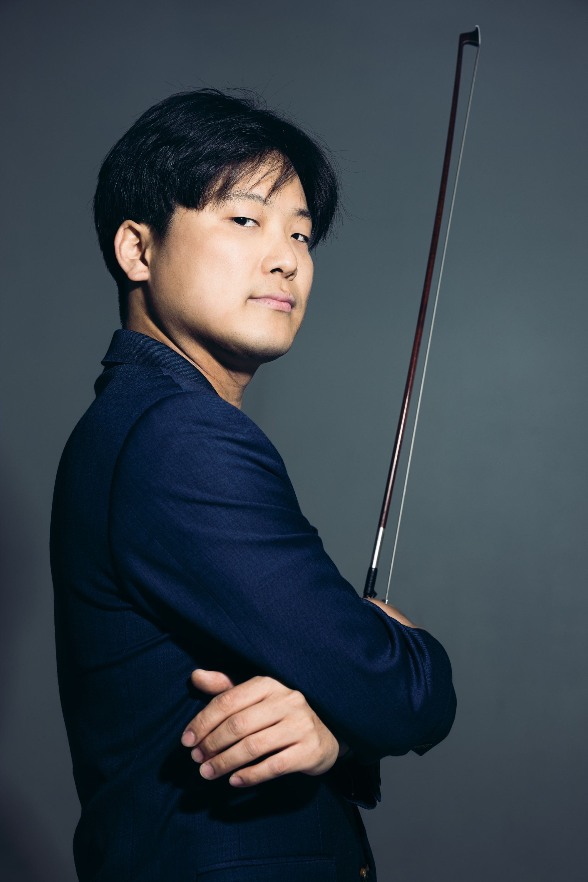 Siwoo Kim in a navy studio portrait