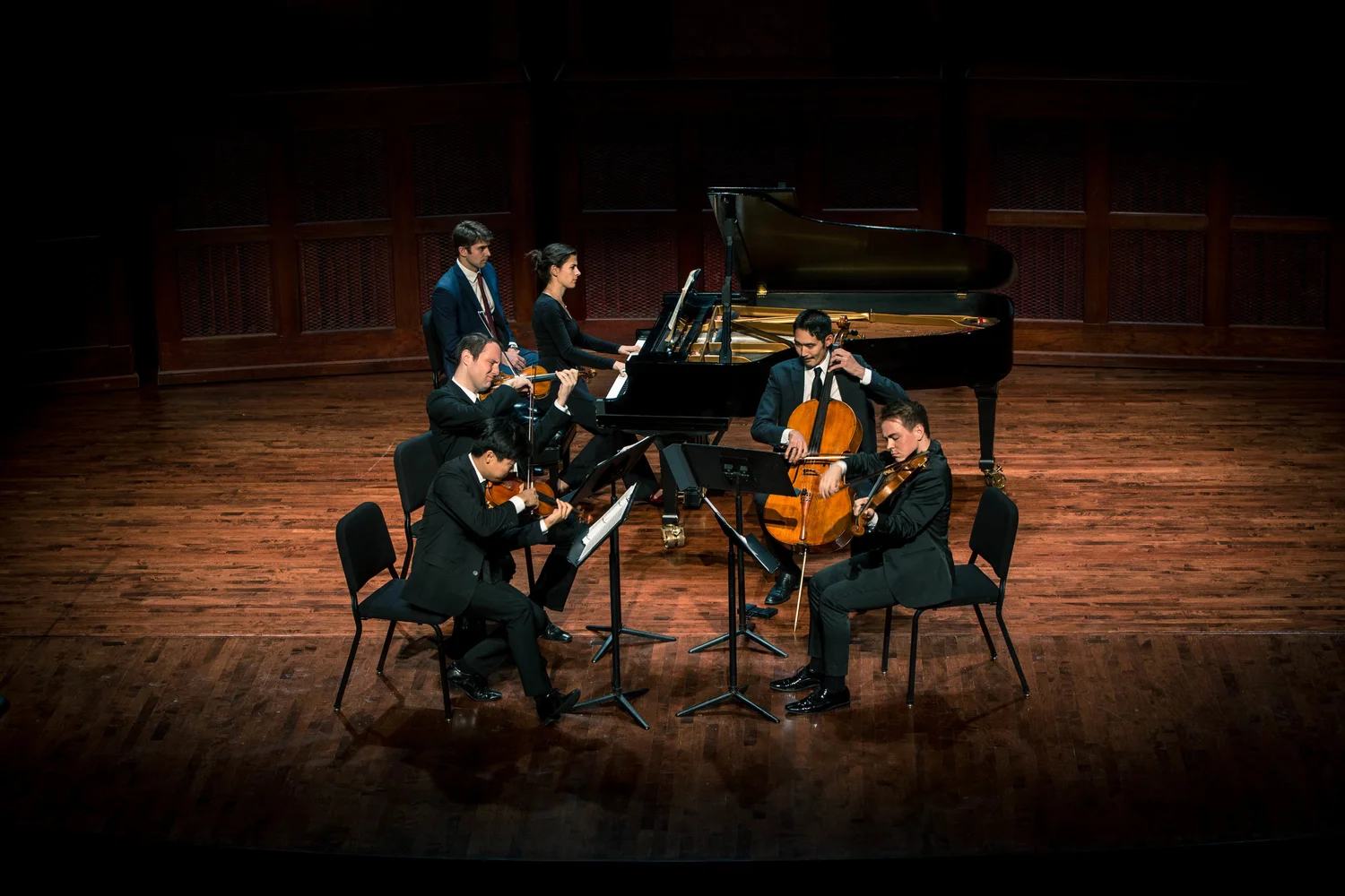 A VIVO ensemble on a warm-lit concert stage